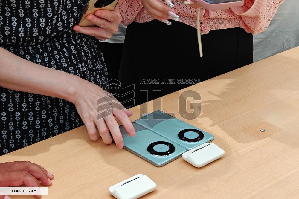 Customers Try Huawei's Mate60 Pro Mobile Phone in Shanghai