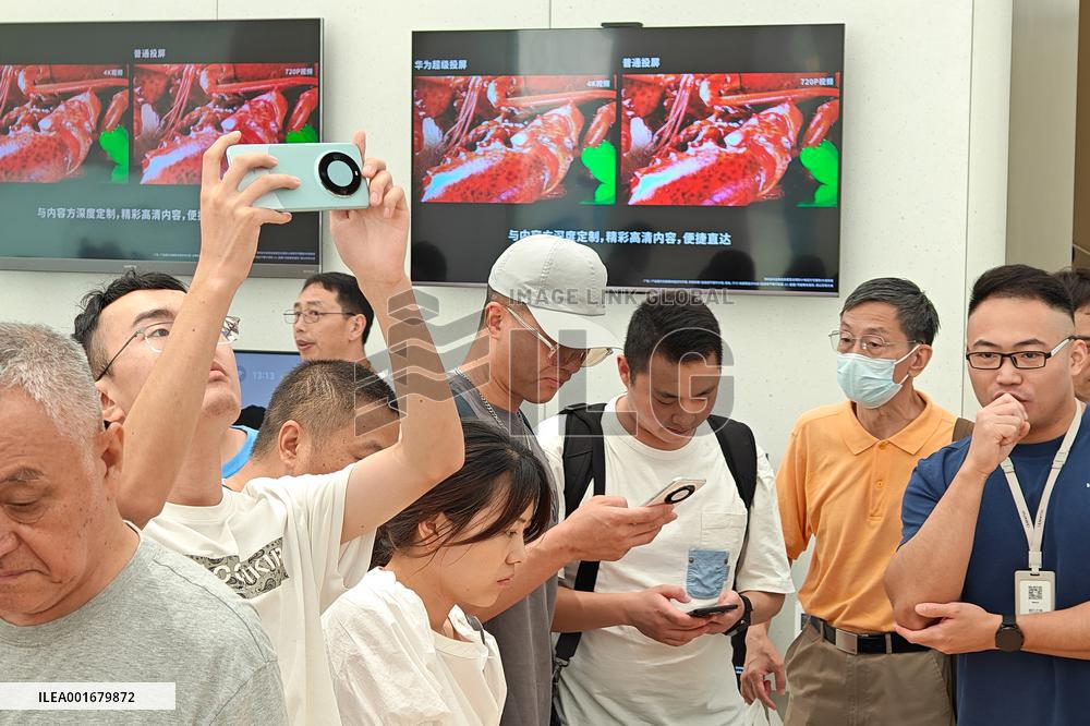 Customers Try Huawei's Mate60 Pro Mobile Phone in Shanghai