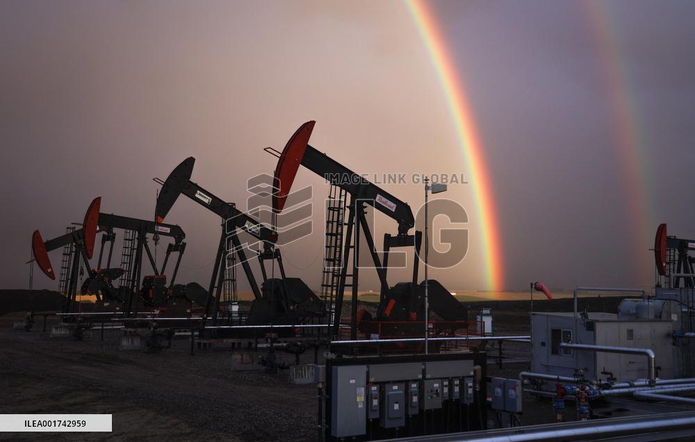 A Rainbow Appears Above An Oil Field - Calgary