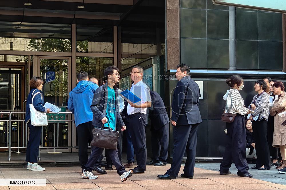 People line up outside the visa office of the U.S. consulate in Shanghai