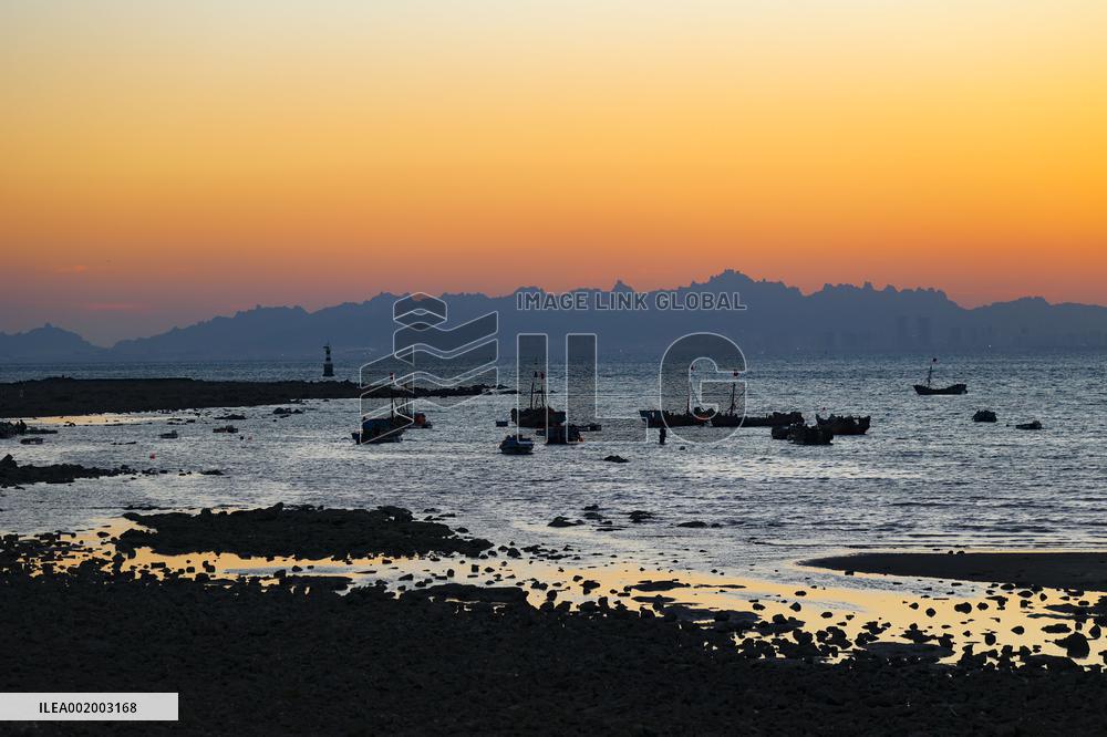 Fishing Boats Sailing at Sunset in Qingdao