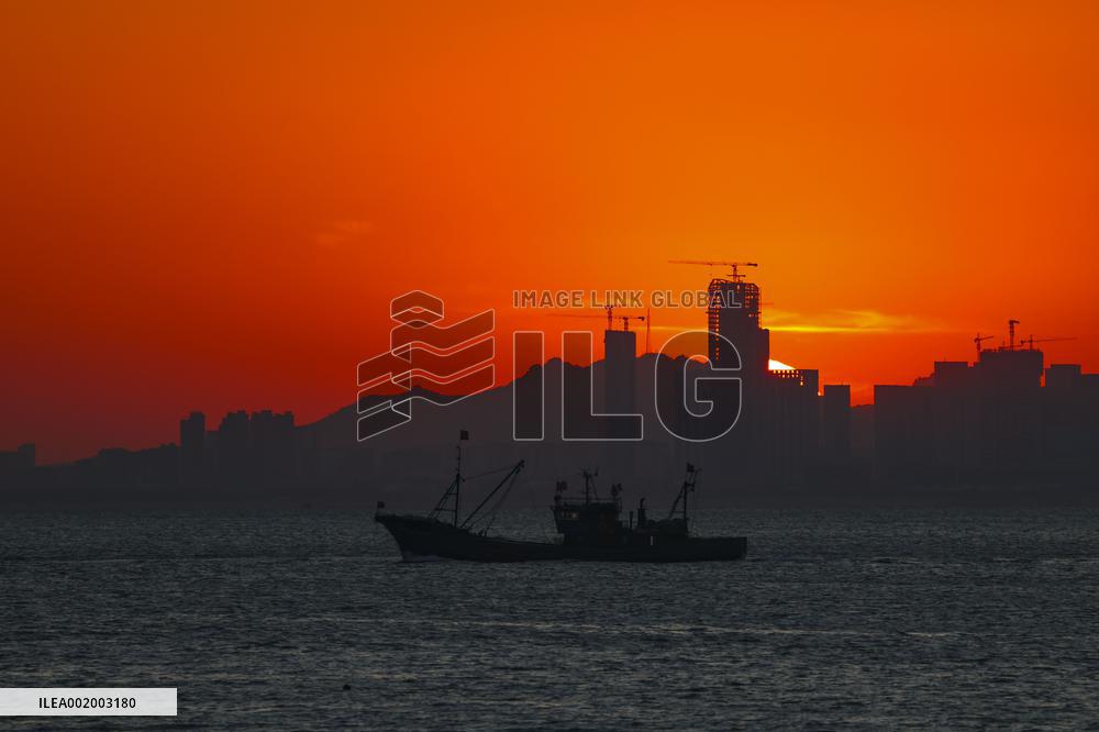Fishing Boats Sailing at Sunset in Qingdao
