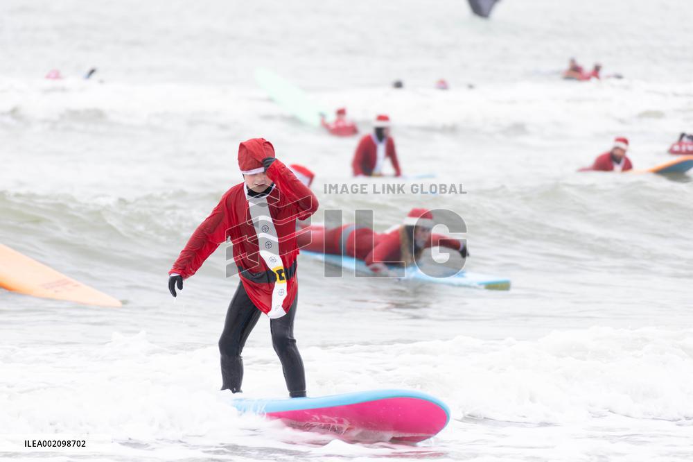THE NETHERLANDS-THE HAGUE-SURFING SANTAS