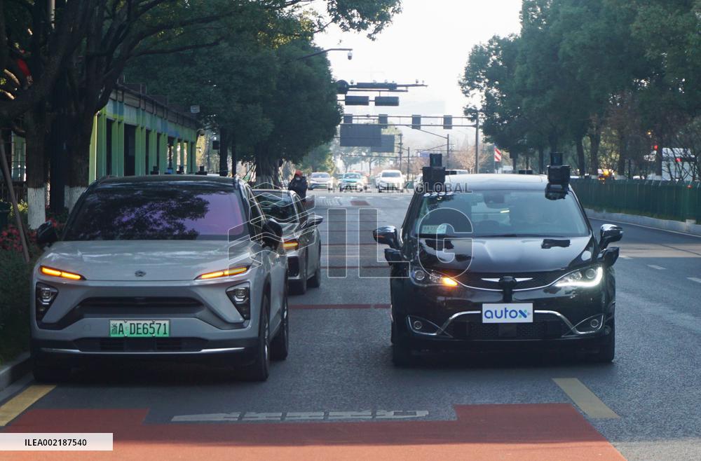 A Driverless Taxi RoboTaxi Runs on A Road in Hangzhou
