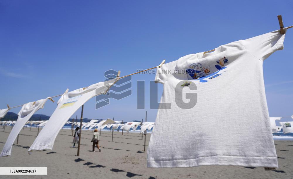 Illustrated T-shirts hang at beach in western Japan