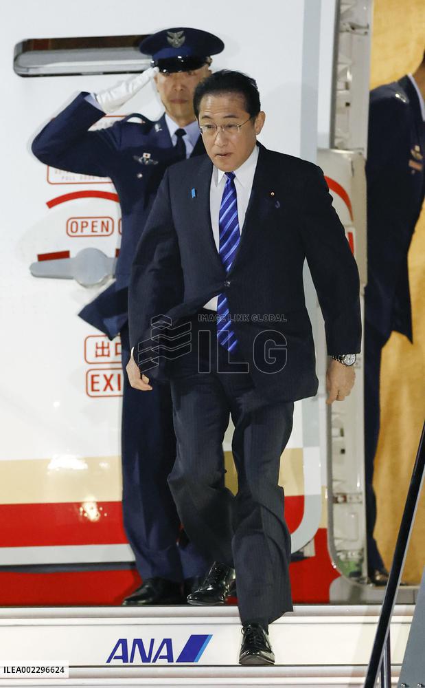 Japan PM returns home