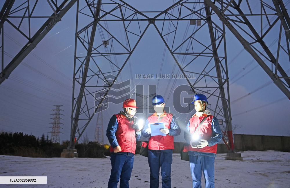Electric Workers Patrol Power Lines in The Snow