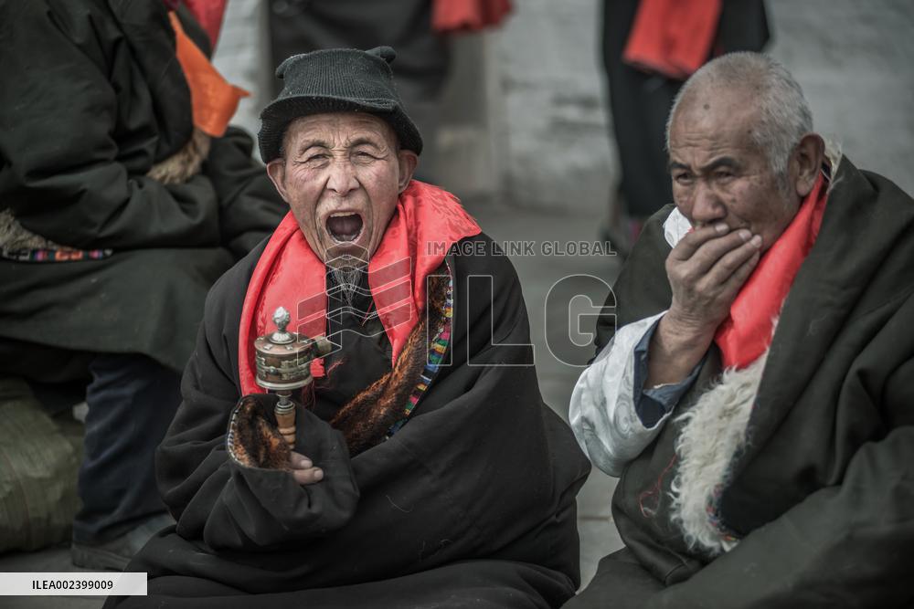 People Worship with a giant thangka at Langmu Temple, China