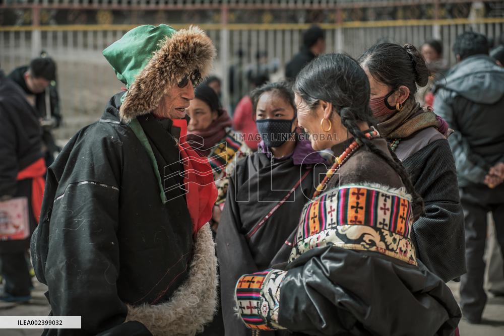 People Worship with a giant thangka at Langmu Temple, China