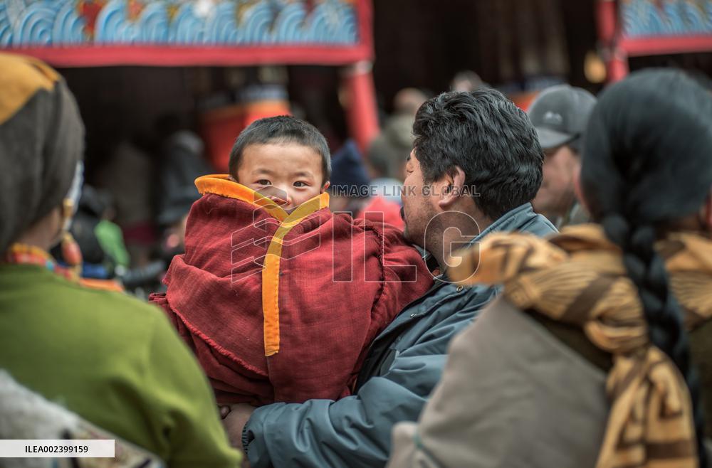 People Worship with a giant thangka at Langmu Temple, China