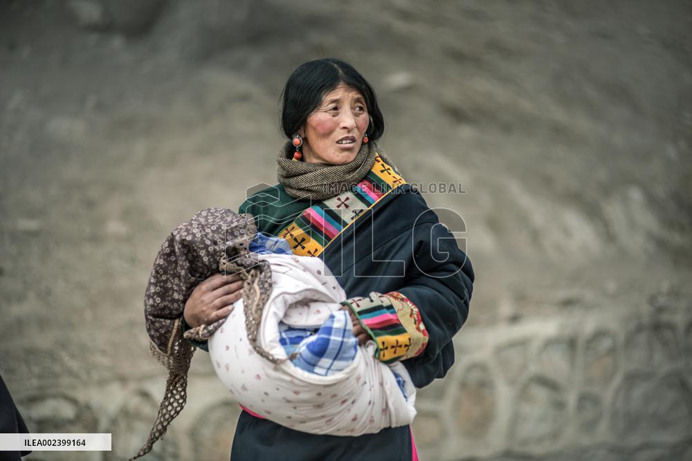 People Worship with a giant thangka at Langmu Temple, China