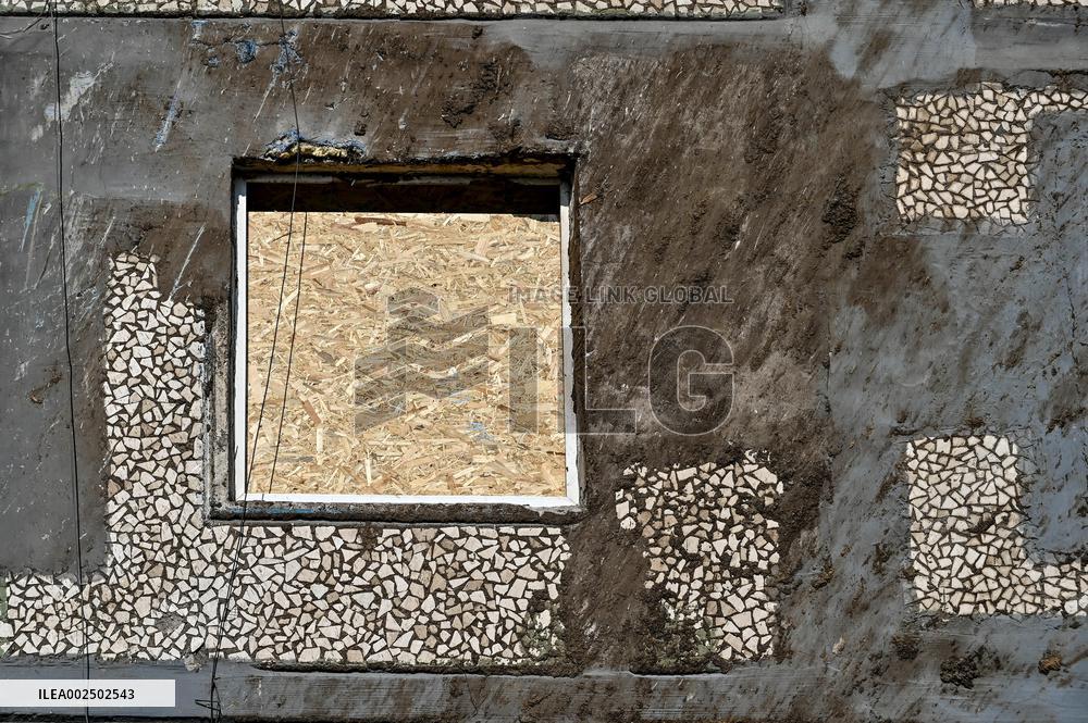 Windows boarded up with OSB sheets after shelling in Zaporizhzhia