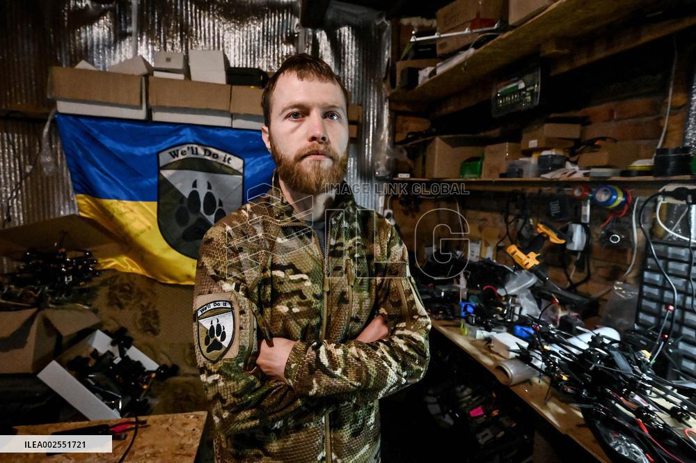 Ukrainian combat drone company soldiers configure FPV drones