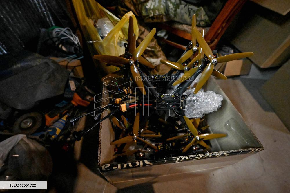 Ukrainian combat drone company soldiers configure FPV drones