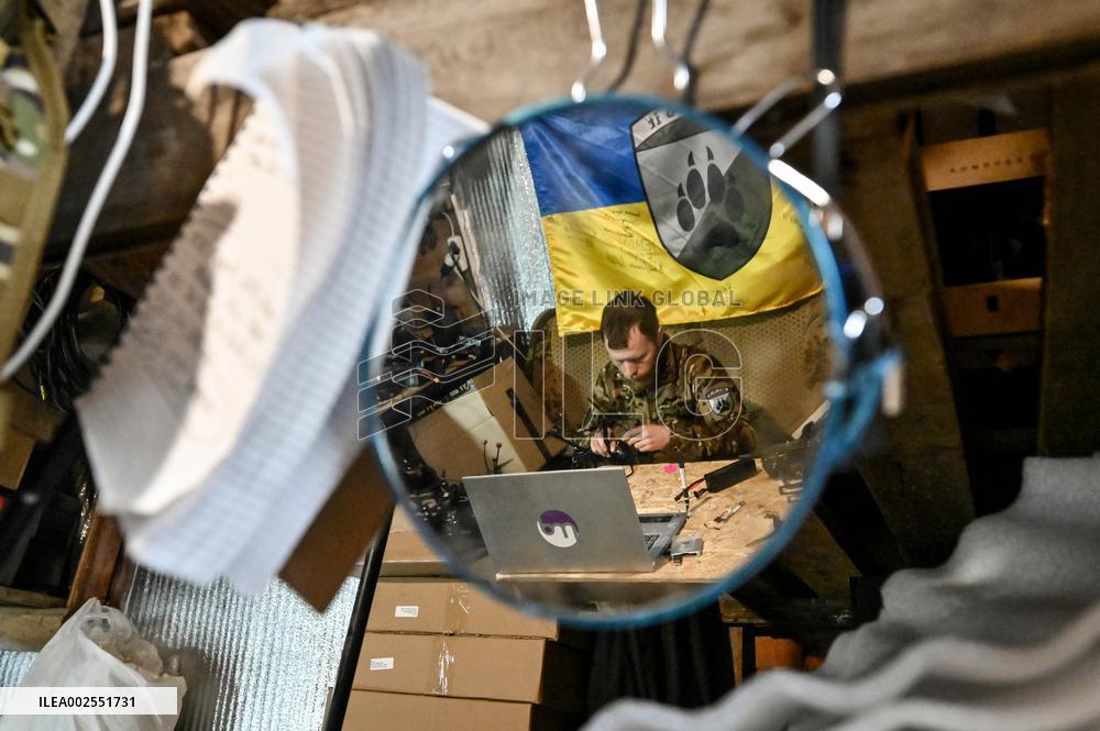 Ukrainian combat drone company soldiers configure FPV drones