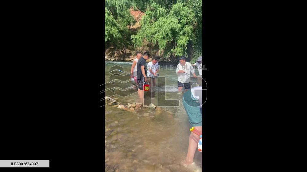 China: Man Rescues Child From Rapids In Qujing, Yunnan
