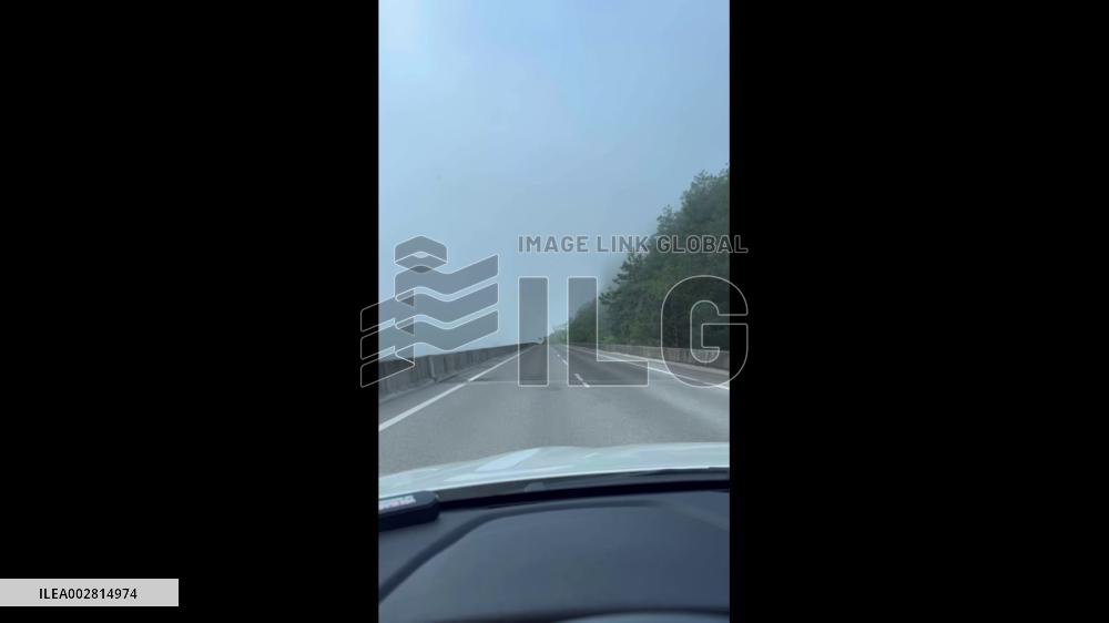 China: Vehicle Drives Through Cloud-Wrapped Highway Bridge In Guizhou