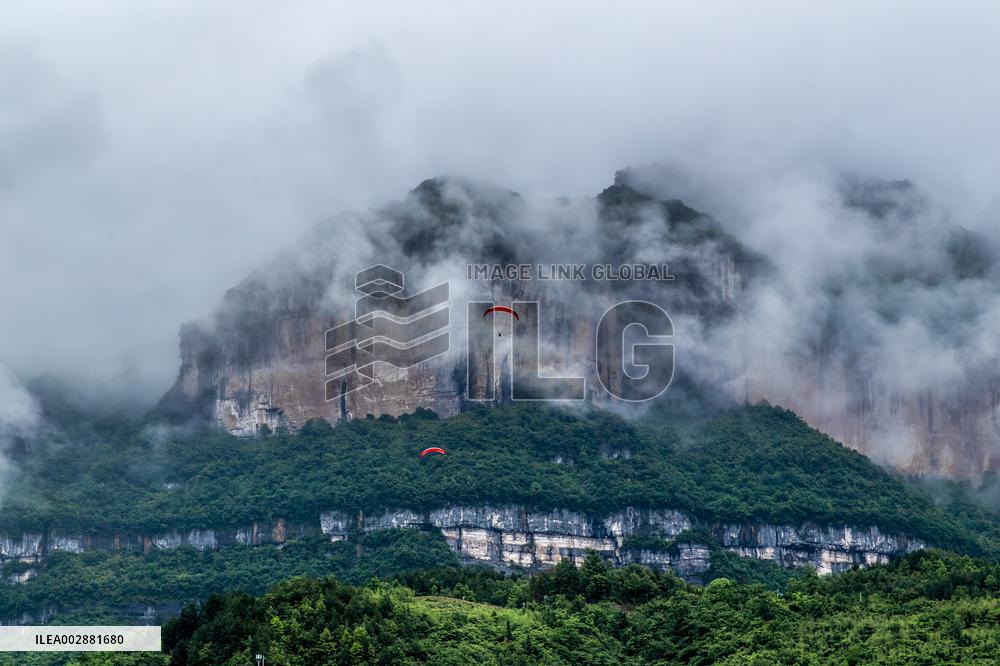 Tourists Ride Paragliders Over The World Natural Heritage site of Jinfo Mountain in Chongqing