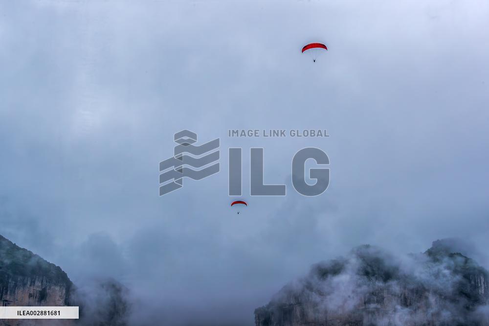 Tourists Ride Paragliders Over The World Natural Heritage site of Jinfo Mountain in Chongqing