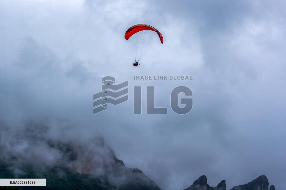 Tourists Ride Paragliders Over The World Natural Heritage site of Jinfo Mountain in Chongqing