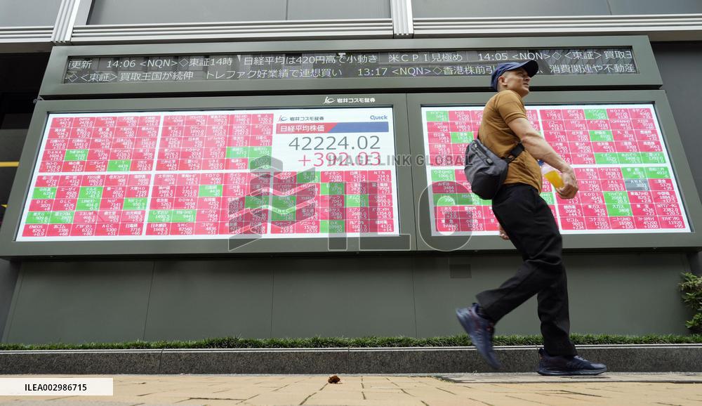 Nikkei ends at new record high