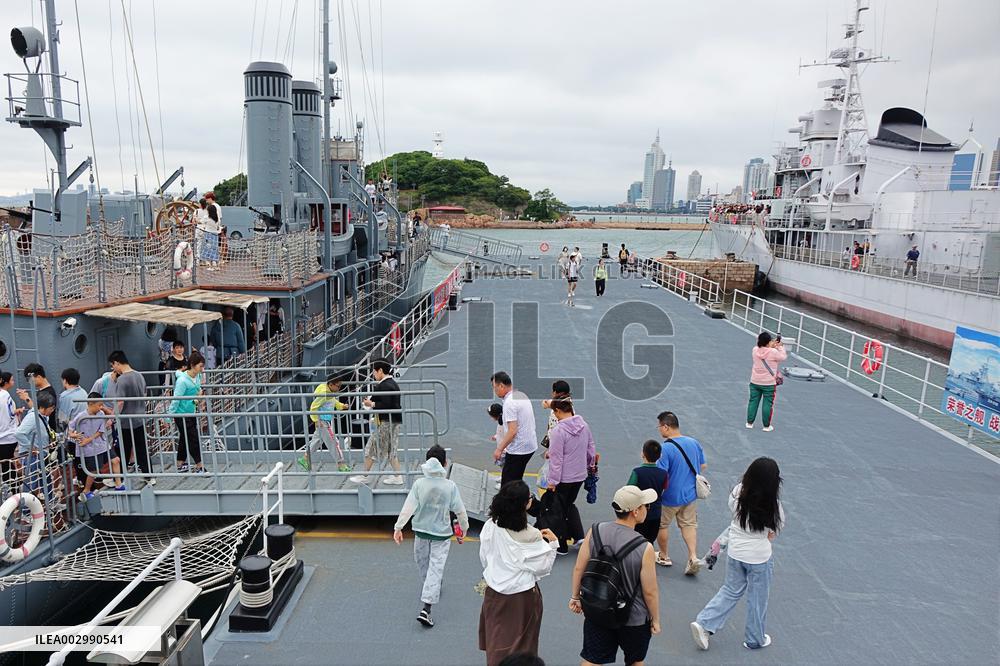 Tourists Visit A Decommissioned Warship in Qingdao