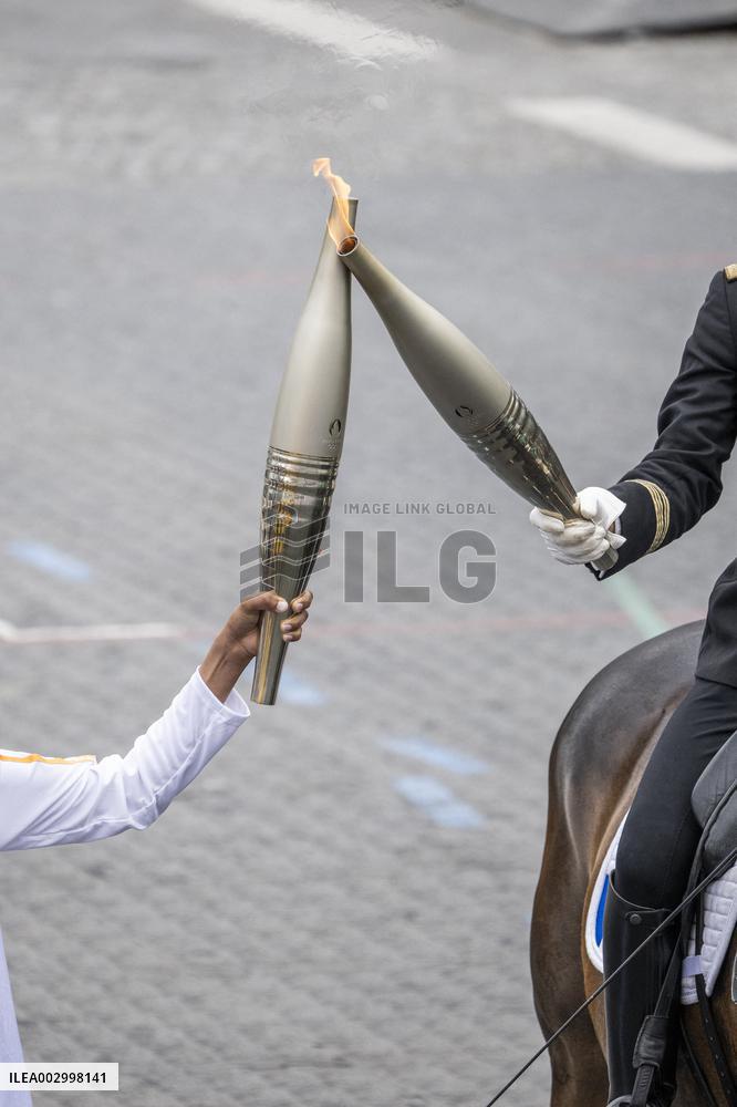 Olympic flame during the annual Bastille Day military parade - Paris