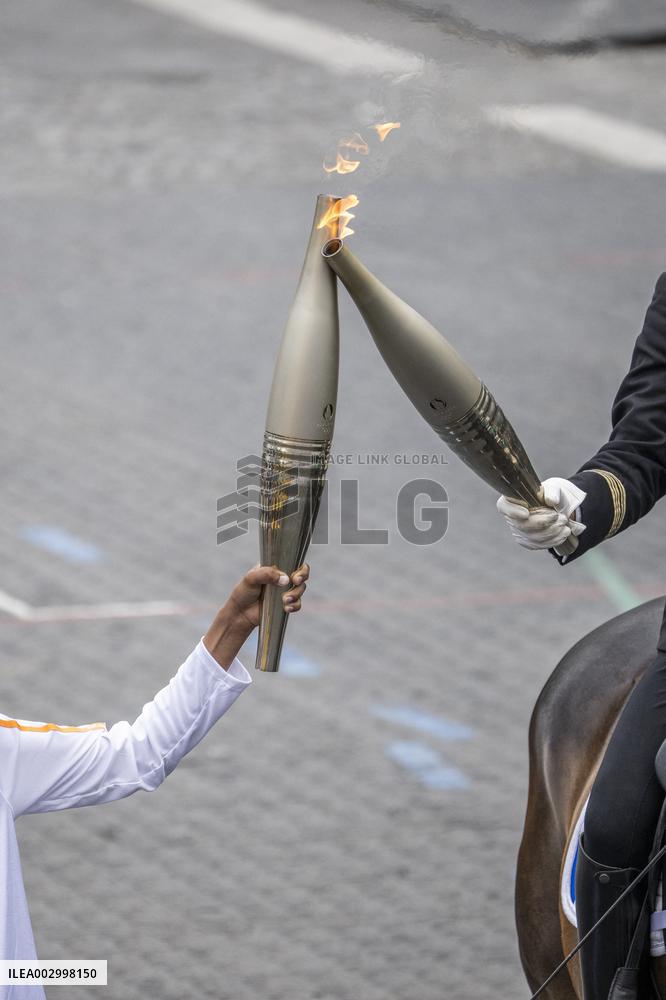 Olympic flame during the annual Bastille Day military parade - Paris