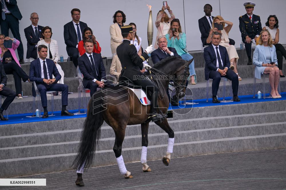 Olympic flame during the annual Bastille Day military parade - Paris