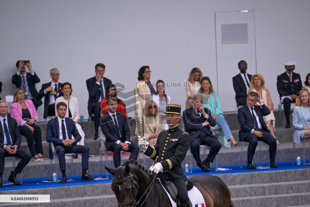 Olympic flame during the annual Bastille Day military parade - Paris