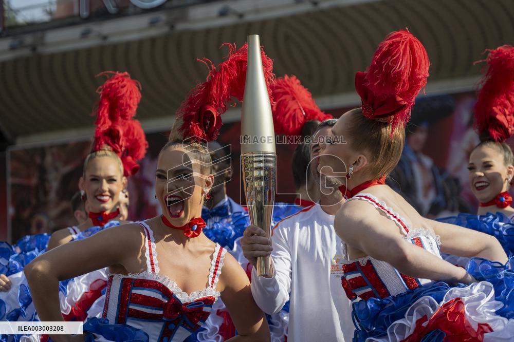 Paris 2024 - The Olympic Flame Stops By The Moulin Rouge