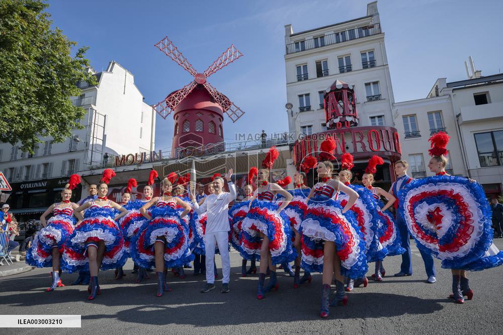 Paris 2024 - The Olympic Flame Stops By The Moulin Rouge