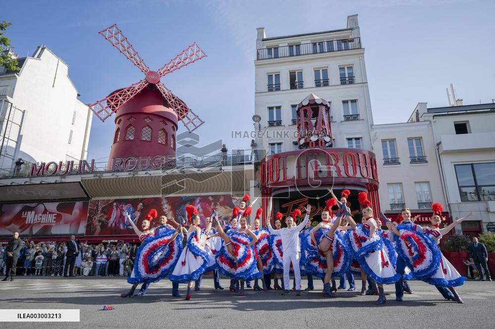 Paris 2024 - The Olympic Flame Stops By The Moulin Rouge