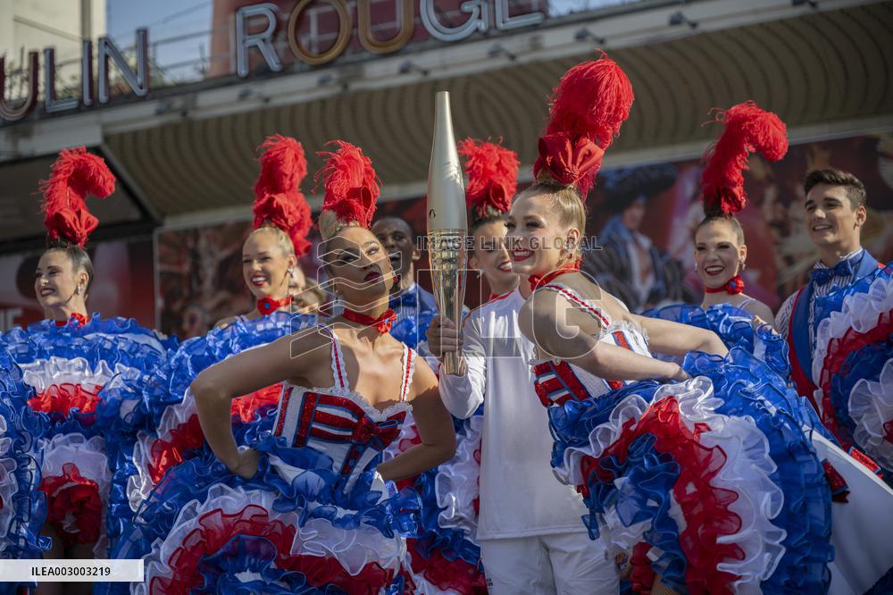 Paris 2024 - The Olympic Flame Stops By The Moulin Rouge