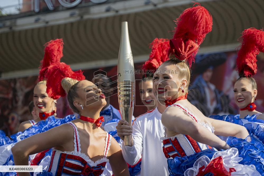 Paris 2024 - The Olympic Flame Stops By The Moulin Rouge