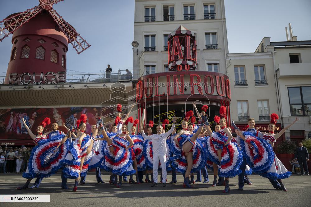 Paris 2024 - The Olympic Flame Stops By The Moulin Rouge