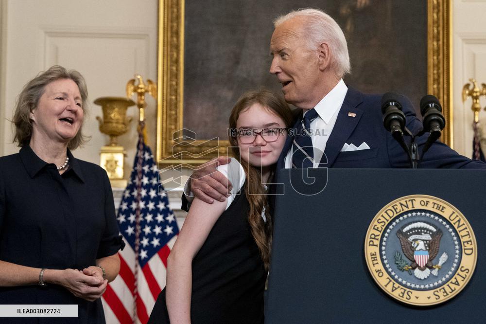 U.S. President Joe Biden stands with hostage familes the White House