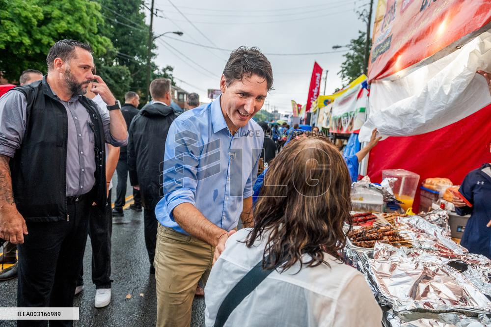 Justin Trudeau greets people as rain falls at Manila festival in Toronto
