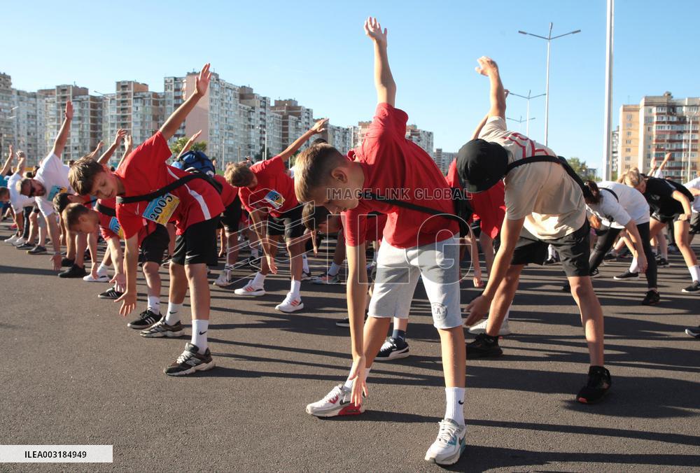 Run with Ukrainian flag in Kyiv