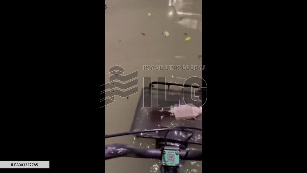 China: Cyclists Wade Through Deep Floodwaters In Wuxi, Jiangsu Province