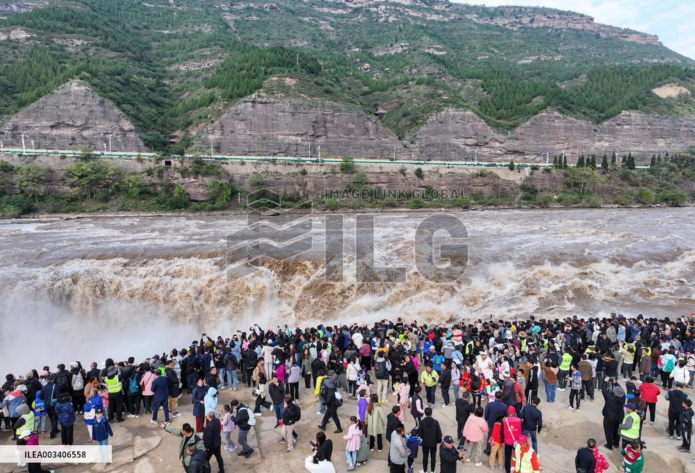 Tourists Visit The Hukou Waterfall - China