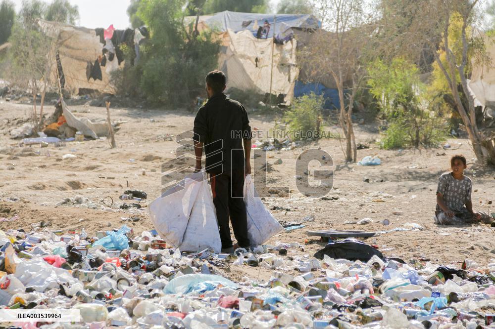 Workers Labor In A Coal-Making Pit - Gaza