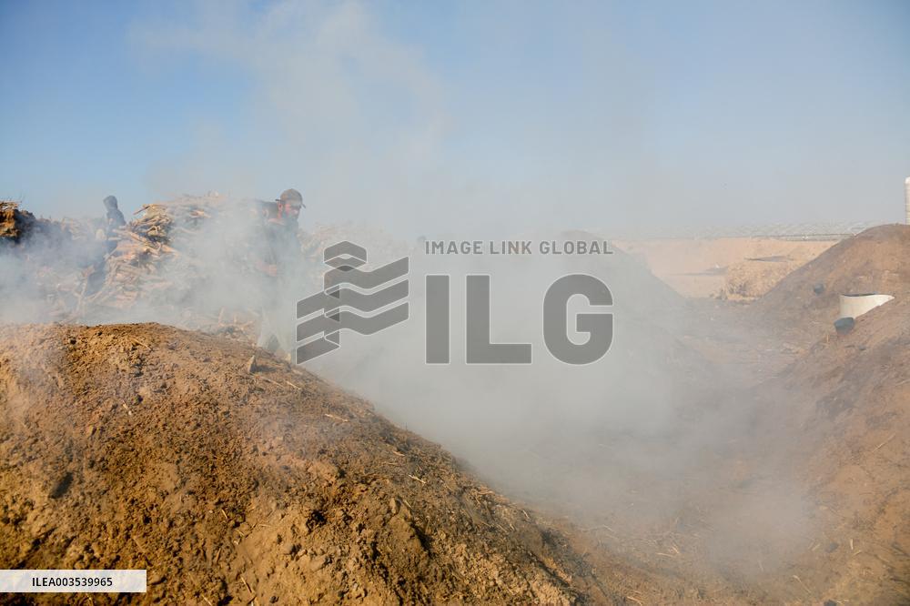 Workers Labor In A Coal-Making Pit - Gaza