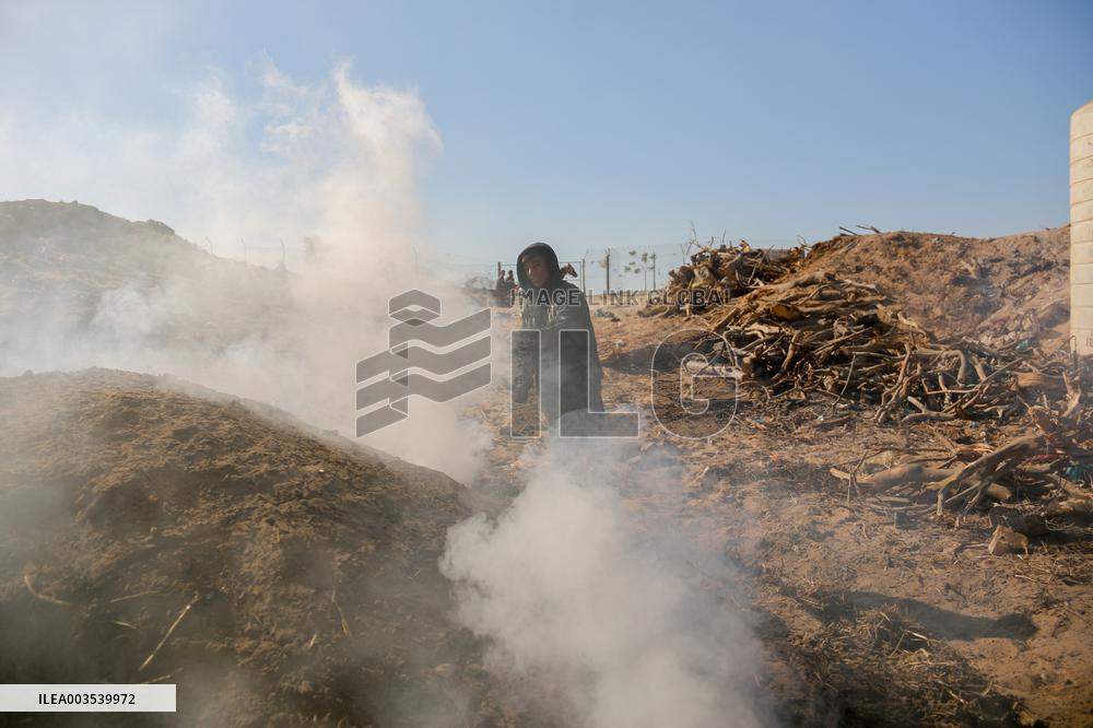 Workers Labor In A Coal-Making Pit - Gaza