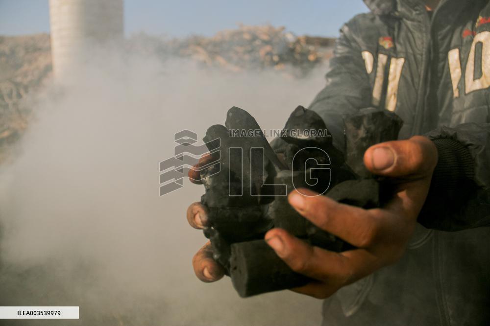 Workers Labor In A Coal-Making Pit - Gaza
