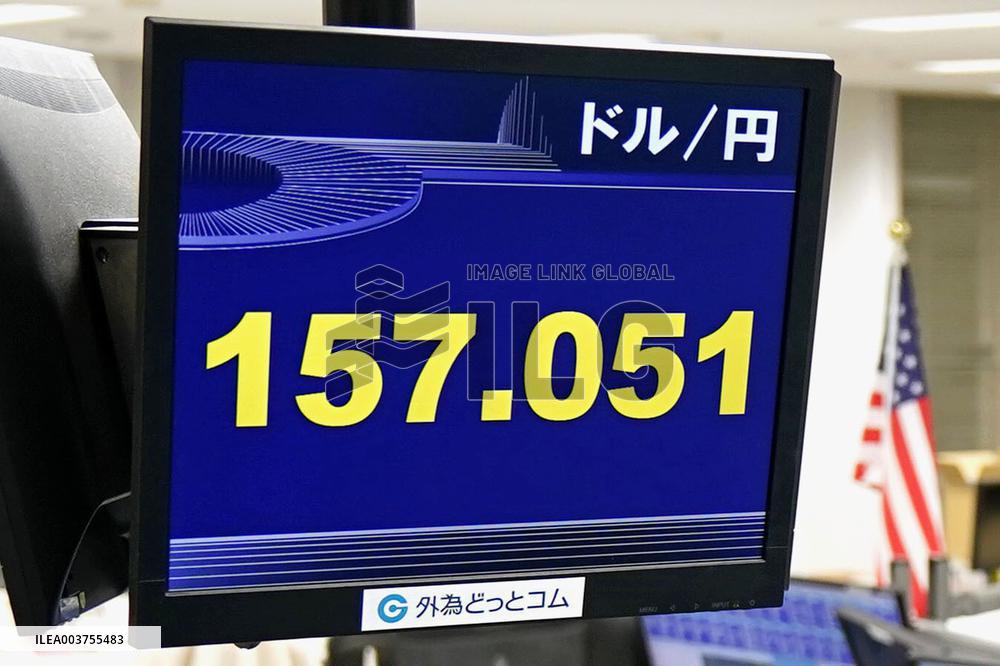 Dollar tops 157 yen