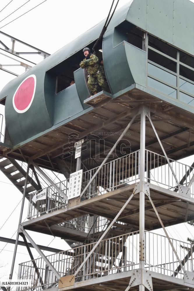 Japan defense minister inspects GSDF parachuting drill