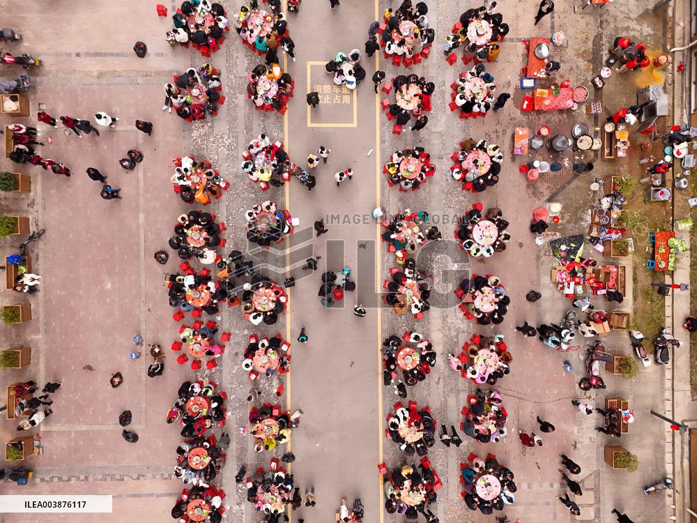 Community Owners Sit Around Tables and Eat Soup