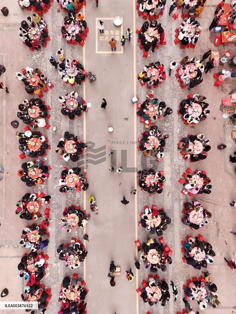 Community Owners Sit Around Tables and Eat Soup