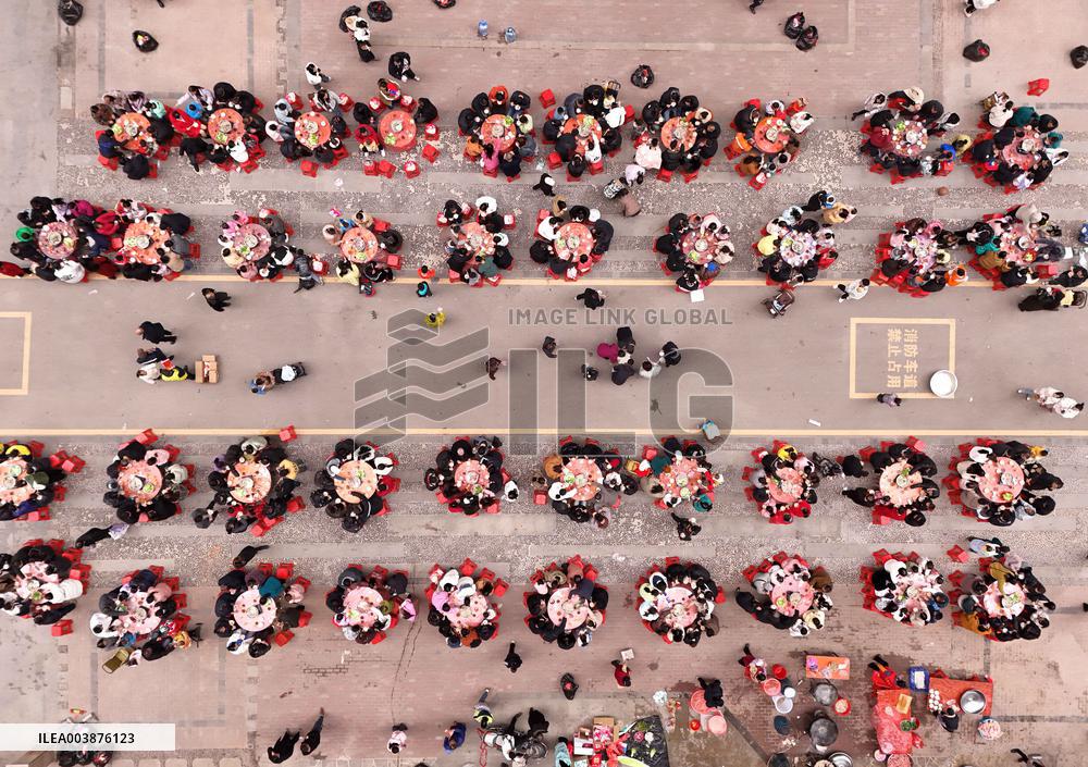 Community Owners Sit Around Tables and Eat Soup